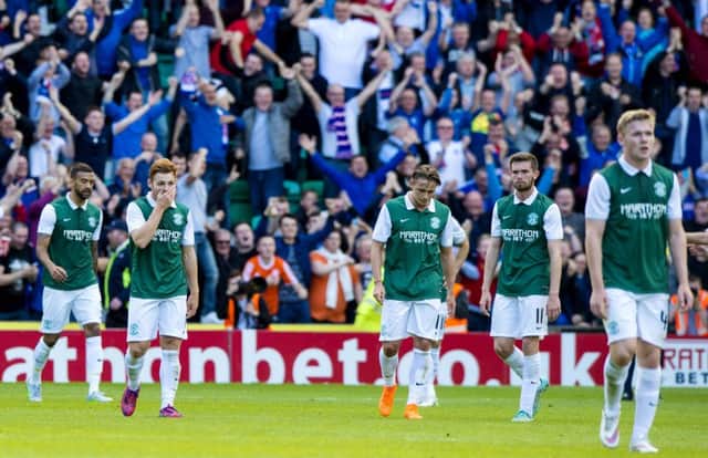 Hibernian players stand dejected at full-time. Picture: SNS