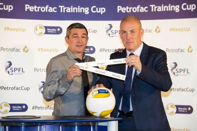 Former Rangers player Charlie Miller joins current manager Mark Warburton at yesterday's Petrofac Training cup draw. Picture: SNS