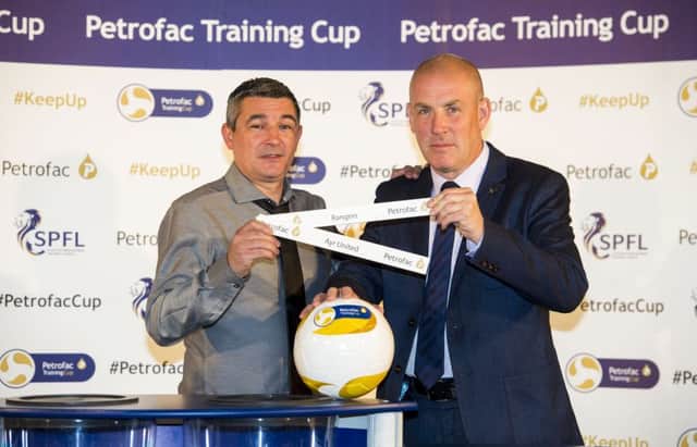 Former Rangers player Charlie Miller joins current manager Mark Warburton at yesterday's Petrofac Training cup draw. Picture: SNS