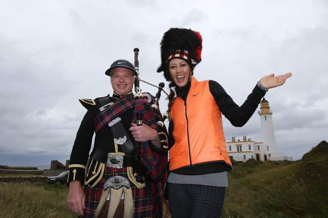 Trump Turnberry Resort piper Bryce McCulloch and Michelle Wie swap headgear with the iconic lighthouse on the Ailsa course. Picture: Getty