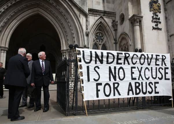 Campaigners attach a banner to the entrance of The High Court in London. Picture: Getty