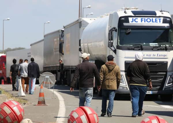 Migrants seen on the main road into Calais ferry port. Picture: PA