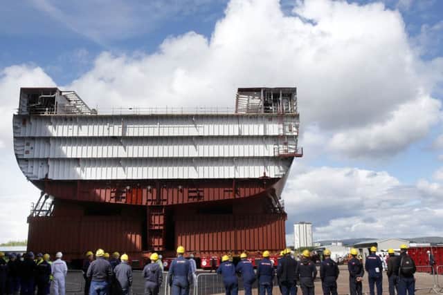 The largest section of HMS Prince of Wales was driven out of the hall at 1mph using nearly 2,000 wheels and a single remote control. Picture: PA