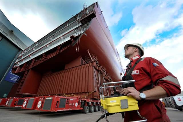 ALE Supervisor Joe Gilbert moves an 11,200 tonne aircraft carrier section out of hangar at BAE System at Govan shipyard. Picture: Hemedia