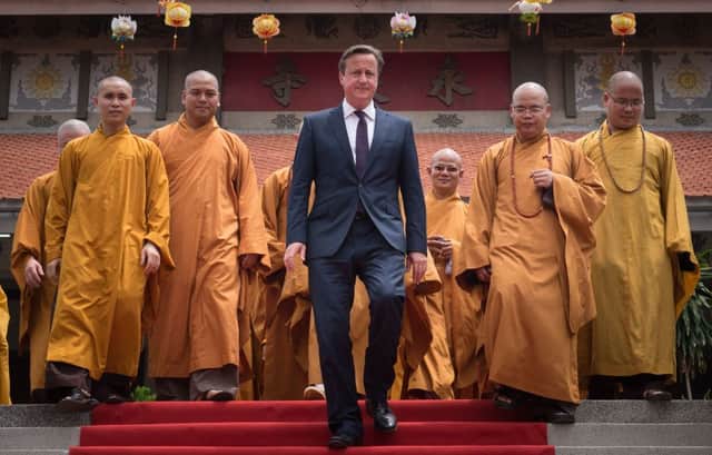David Cameron visits Buddhist temple in Ho Chi Minh City, becoming first Prime Minister to visit Vietnam, before flying to Malaysia. Picture: PA