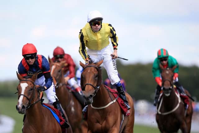 Jamie Spencer, centre, celebrates after piloting Big Orange to a thrilling win in the Qatar Goodwood Cup. Picture: PA