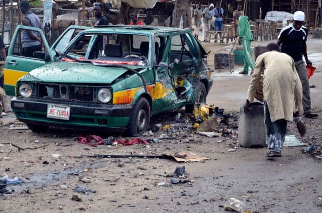 Bystanders sift through the debris at Gomboru market in Maiduguri, in northeastern Nigeria. Picture: Getty