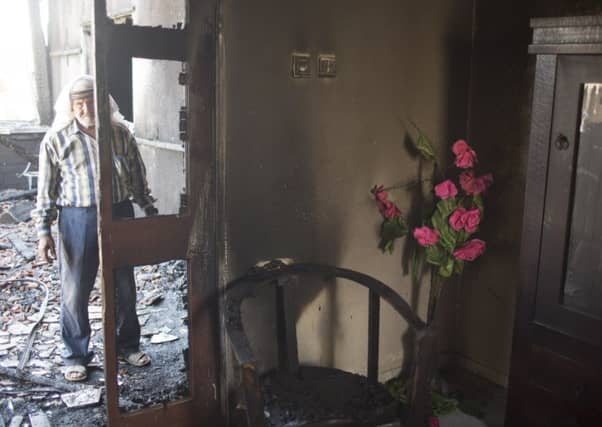 Relatives of 18 month old baby, Ali Saad-Dawabsheh, view the remains of their house after a fire which was suspected to have been set by Jewish extremists on July 31, in the Palestinian village of Duma, West Bank. Picture: Getty