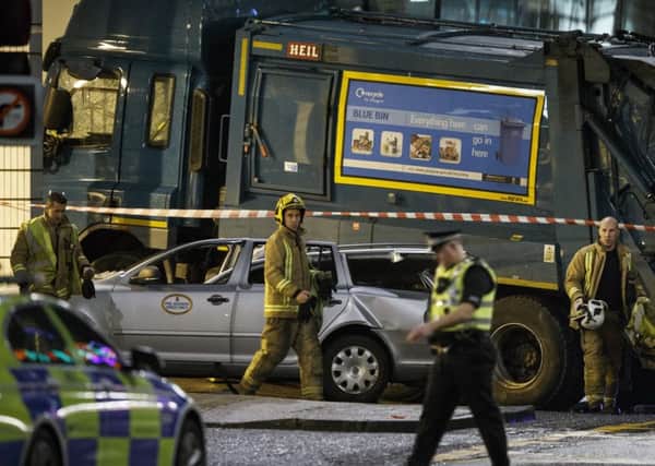 Emergency workers at the scene of last December's bin lorry crash in Glasgow city centre, which killed six people. Picture: Robert Perry