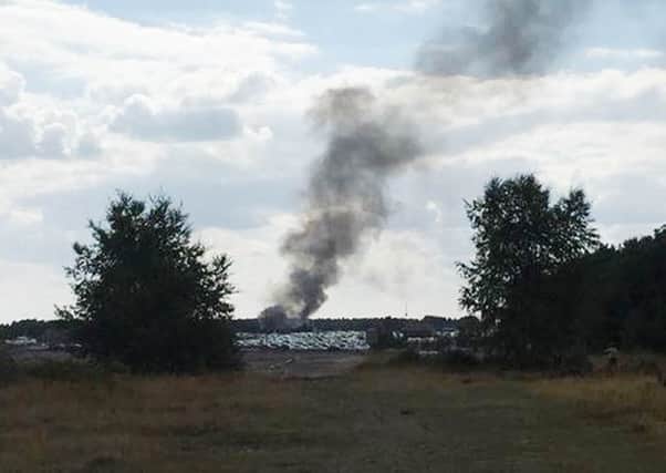 Smoke rising from Blackbushe airport after a light aircraft crashed into a car auction shortly after take-off. Picture: PA/Twitter