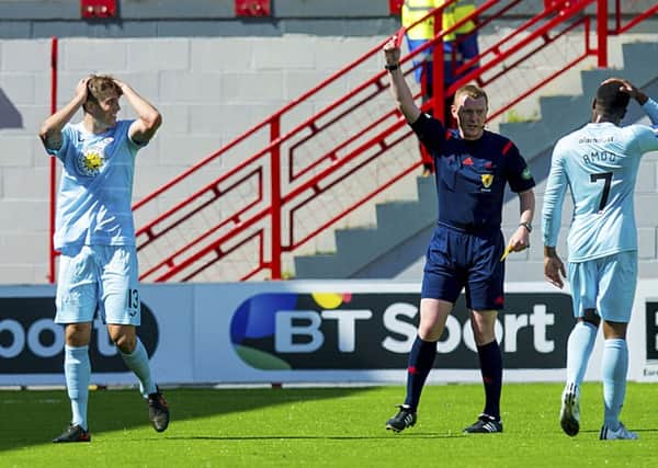 Partick's Frederic Frans is shown the red card for a second bookable offence. Picture: SNS