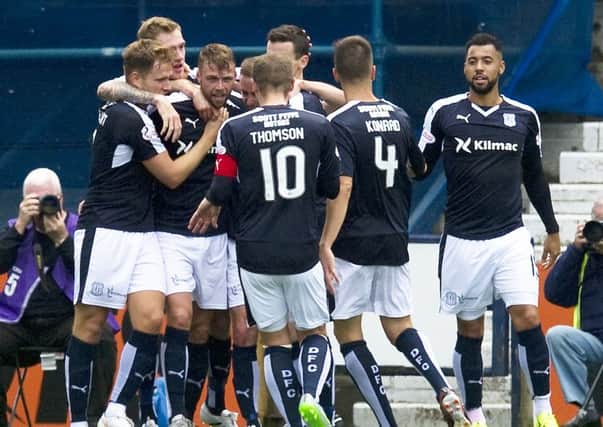 Dundee's Rory Loy, third from left, celebrates his goal with his team-mates. Picture: SNS