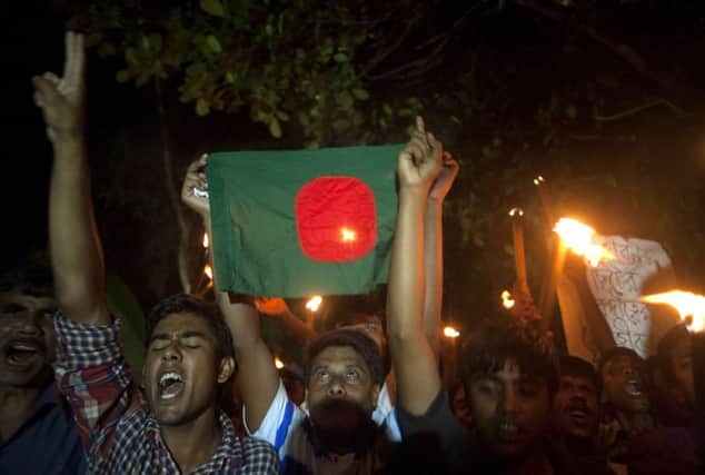 Former Indian enclave residents carry torches and a Bangladesh flag. Picture: Getty