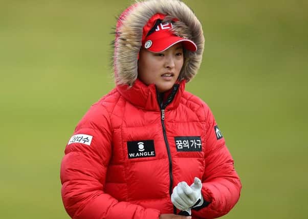 Jin-Young Ko of South Korea wraps up against the elements at the Womens British Open in Turnberry yesterday. Picture: Getty
