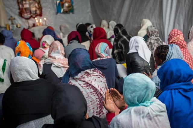 Ethiopian and Eritrean worshippers attend an Orthodox serivce at a church in a make shift camp near the port of Calais. Picture: Getty Images