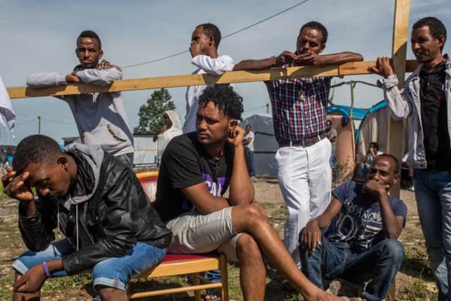 People gather outside a church following an Orthodox service for Ethiopian and Eritrean worshippers in a makeshift camp near the port of Calais. Picture: Getty Images