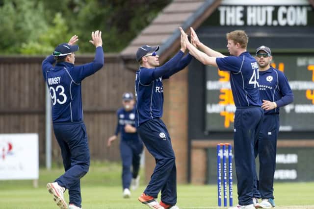 Scotland bowler Ally Evans, centre right, celebrates one of his wickets against Nepal at Ayr. Picture: Donald MacLeod