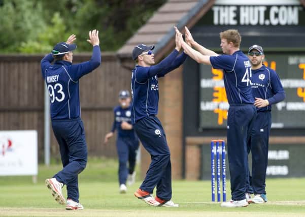 Scotland bowler Ally Evans, centre right, celebrates one of his wickets against Nepal at Ayr. Picture: Donald MacLeod