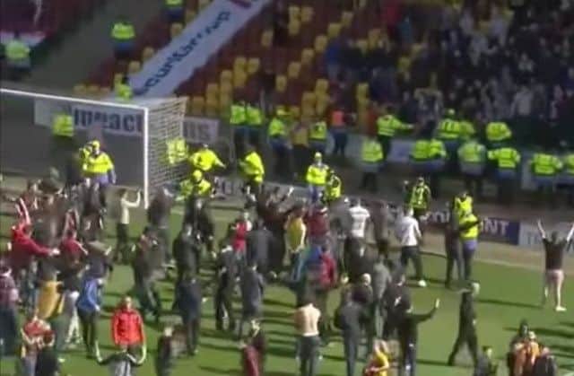 Motherwell fans on the pitch after the play-off win over Rangers. Picture: Contributed