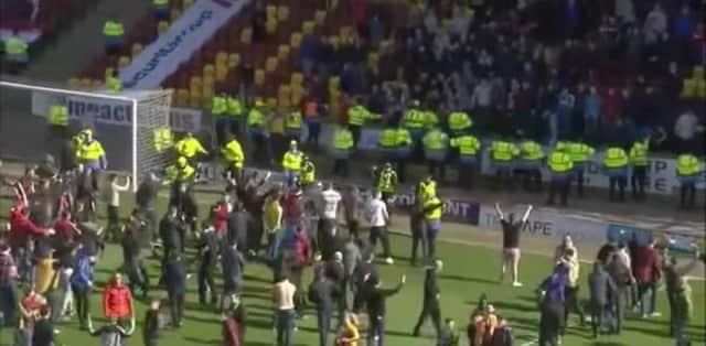 Motherwell fans on the pitch after the play-off win over Rangers. Picture: Contributed