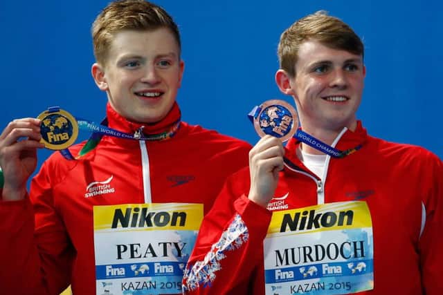 Adam Peaty and Ross Murdoch pose with their medals after finishing first and third in the 100m final in Kazan yesterday. Picture: Getty