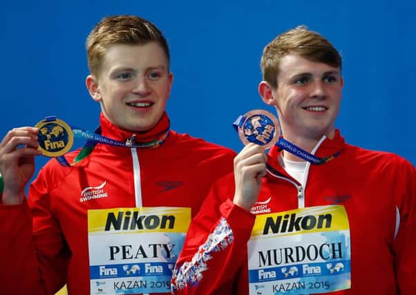 Adam Peaty and Ross Murdoch pose with their medals after finishing first and third in the 100m final in Kazan yesterday. Picture: Getty