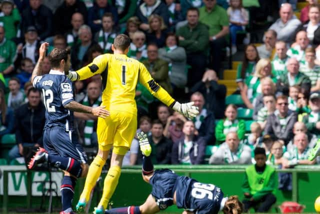 Celtic goalkeeper Craig Gordon brings down Jackson Irvine and is shown a yellow card. Picture: SNS