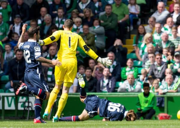 Celtic goalkeeper Craig Gordon brings down Jackson Irvine and is shown a yellow card. Picture: SNS