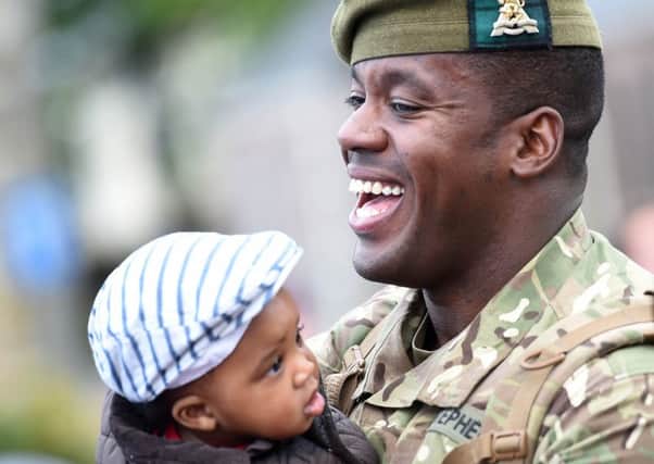 Lance Corporal Dylan Stephen with son Michael at Glencorse Barracks near Penicuik in Midlothian. Picture: PA