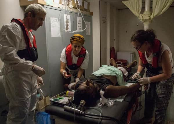 Medics from Medecins Sans Frontieres treat one of the migrants rescued from the Mediterranean. Picture: Contributed