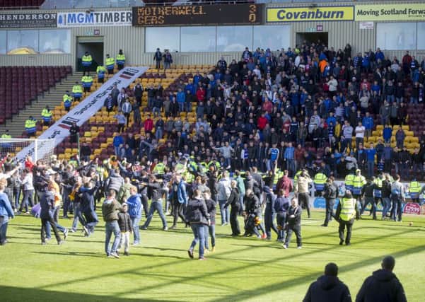 Motherwell fans on the pitch appear to taunt the Rangers fans in the stand at the end of the Scottish Premiership play-off final 2nd leg at  Fir Park. Picture: Getty