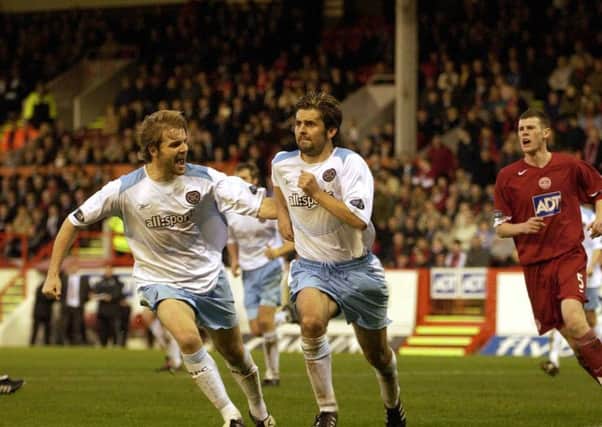 Paul Hartley celebrates scoring a penalty with Robbie Neilson back in 2004. Picture: Kate Chandler