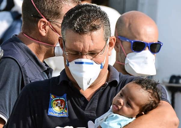 A baby rescued from the migrant boat that sank on Wednesday. Picture: Getty
