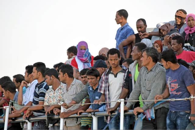 Migrants wait to disembark after an Italian Coast Guard craft rescued them off Sicily yesterday. Picture: Getty