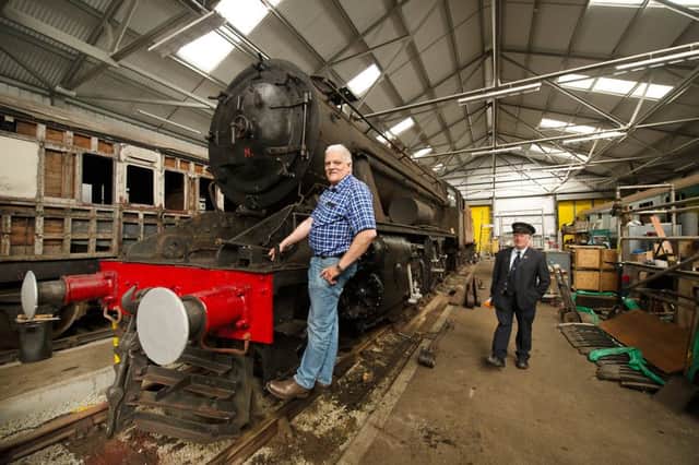 Mark Ashmole with the 73-year-old Stanier class 8F freight engine which the SRPS hopes to restore fully at its Boness site. Picture: John Devlin