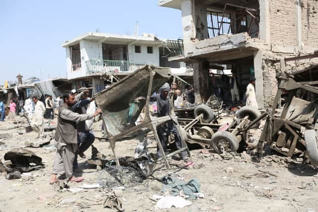 Wreckage is cleared following Fridays truck bomb in central Kabul. Picture: AP