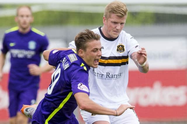 Hibernian's Scott Allan, left, battles for the ball against Dumbarton's William Gibson. Picture: SNS