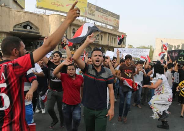 Protesters chant anti-Iraqi government slogans in Tahrir Square in Baghdad. Picture: AP