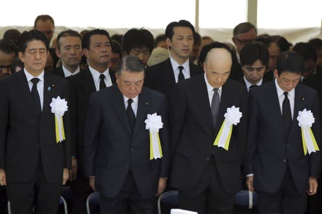Japan's prime minister Shinzo Abe, left, attends the ceremony. Picture: AP