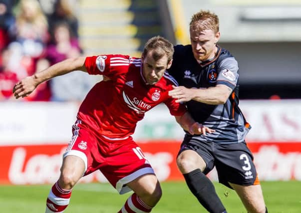 Steven Smith puts a challenge in on Aberdeen's Niall McGinn. Picture: SNS