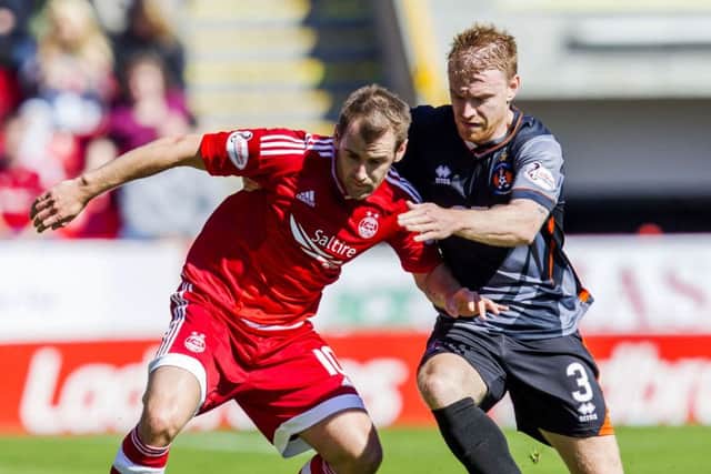 Steven Smith puts a challenge in on Aberdeen's Niall McGinn. Picture: SNS