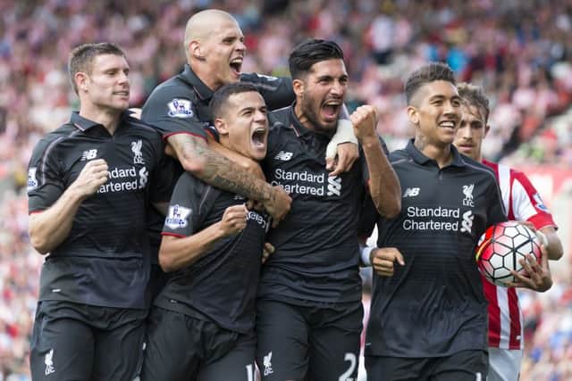 Philippe Coutinho, third from the left, is mobbed by his team-mates after his goal. Picture: AP