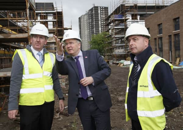 Glasgow City Council leader Gordon Matheson (centre) in the Gorbals as he surveys new housing being built. Picture: Robert Perry