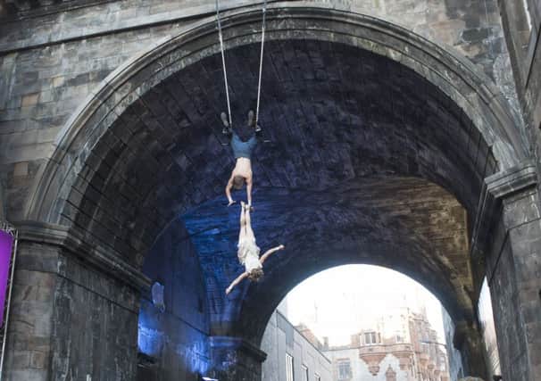Circus artists Josa Koelbel and Bellina Sorensson, from the Edinburgh Festival Fringe show Dolls perform a trapeze stunt hanging from the George IV Bridge in Edinburgh.

 Picture: Jane Barlow
