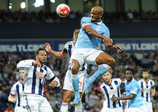 Manchester City captain Vincent Kompany scores his side's third goal against West Brom at The Hawthorns last night.  Picture: Rui Vieira/AP