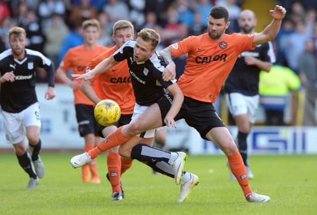 Dundee Utd's Mark Durnan (right) challenges Greg Stewart. Picture: SNS