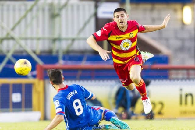 Ross Draper (left) tackles Partick Thistle's Stuart Bannigan. Picture: SNS