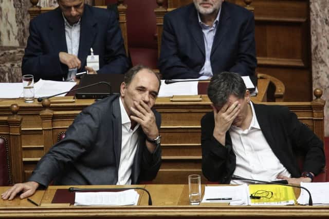 Finance minister Euclid Tsakalotos, right, and economy minister Giorgos Stathakis attend a meeting ahead of the vote. Picture: AP
