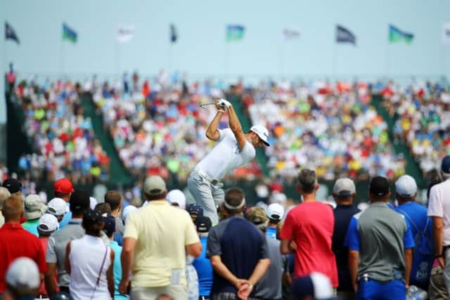 Early leader Dustin Johnson plays his tee shot at the sixth hole during yesterdays first round. Picture: Getty