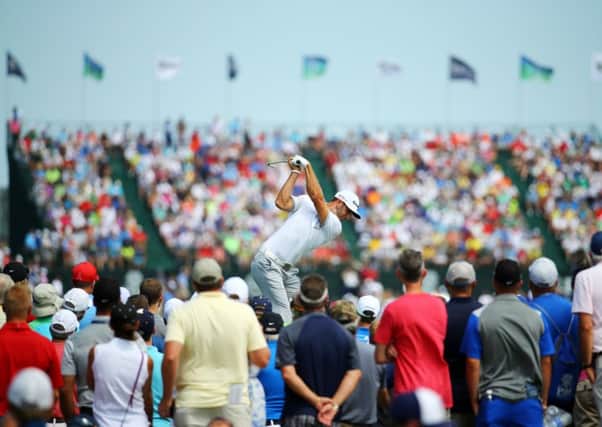 Early leader Dustin Johnson plays his tee shot at the sixth hole during yesterdays first round. Picture: Getty